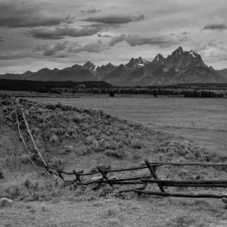 Grand Teton as seen from just outside a ranch in the distance.  This fence does not do much to keep the wandering bison out.  I saw them jump fences like this with ease.  