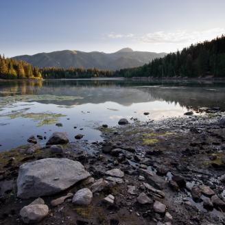 A thin layer of mist floats across Payson Lake during an August sunrise.  