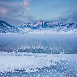 Mount Timpanogos rises above frozen Deer Creek on a very chilly winter morning. a