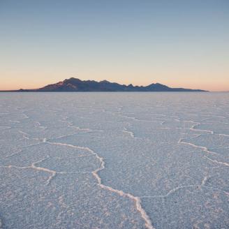 The sun sets over the cracked salty landscape of Utah's West Desert.