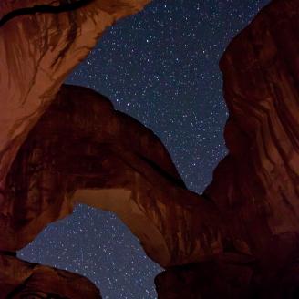 Stars shine through the iconic Double Arch at Arches National Park